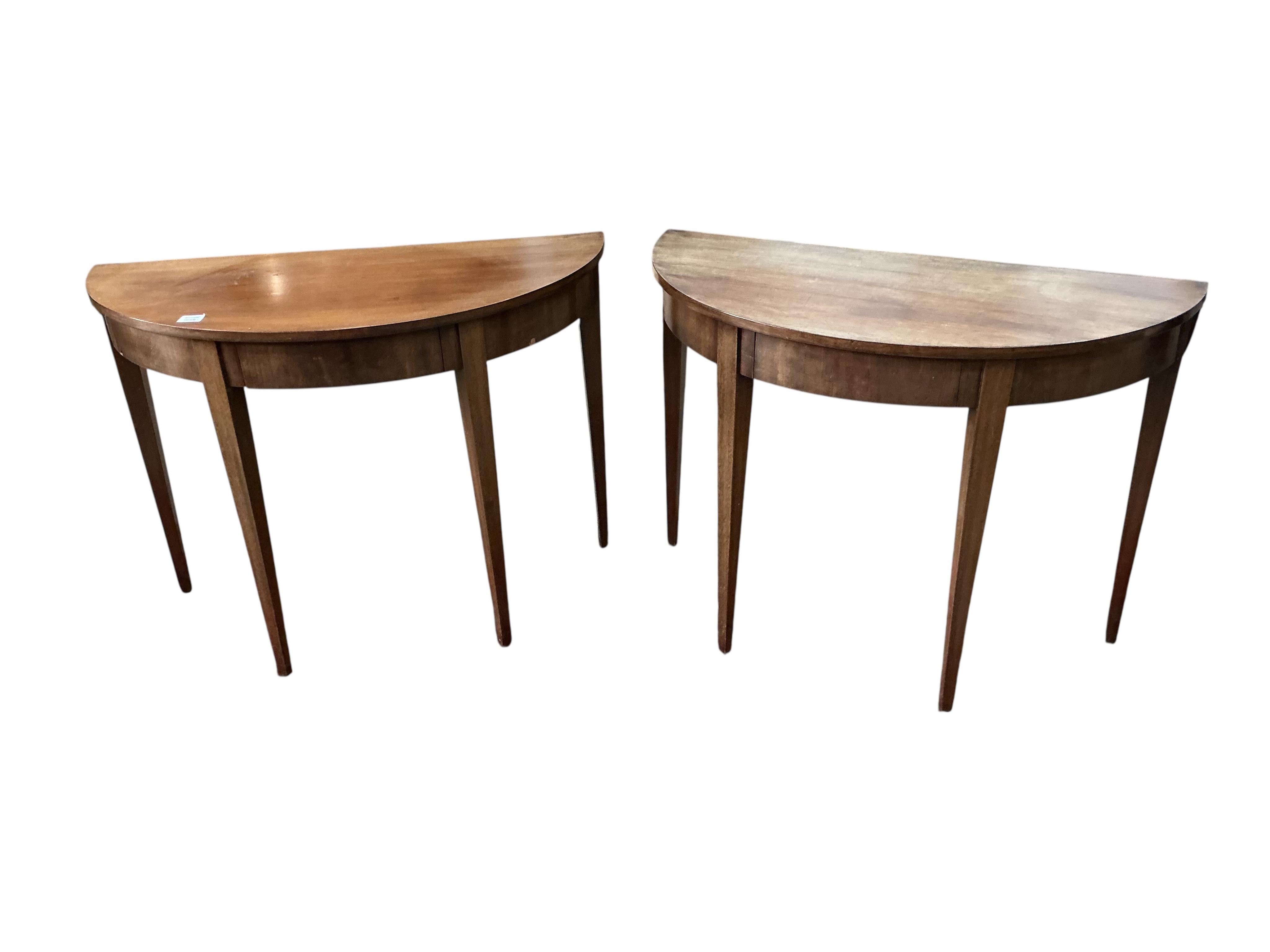 A pair of George III mahogany 'D' shaped tables, each fitted with a single drawer, each width 104cm, depth 50cm, height 76cm together with a pair of George III mahogany dining chairs